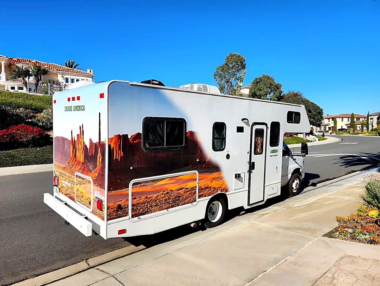 Cruise America motorhome parked under a blue San Clemente sky