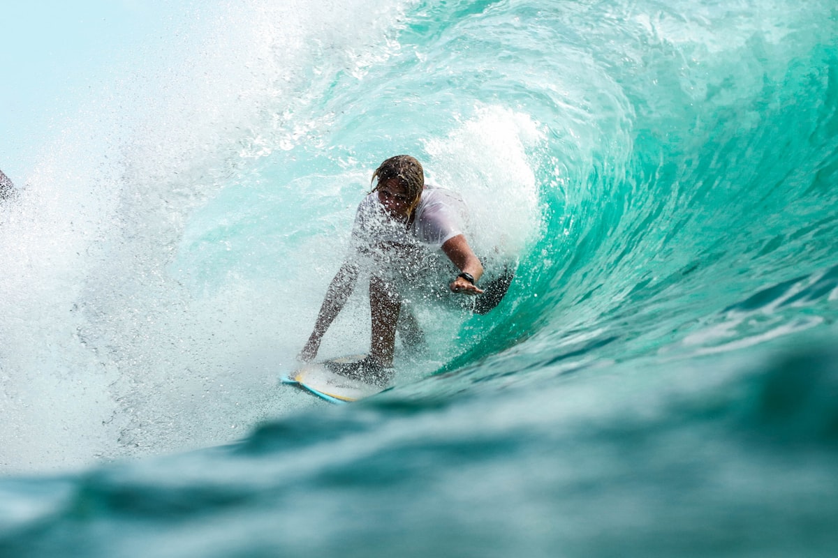 Surfer riding a turquoise wave